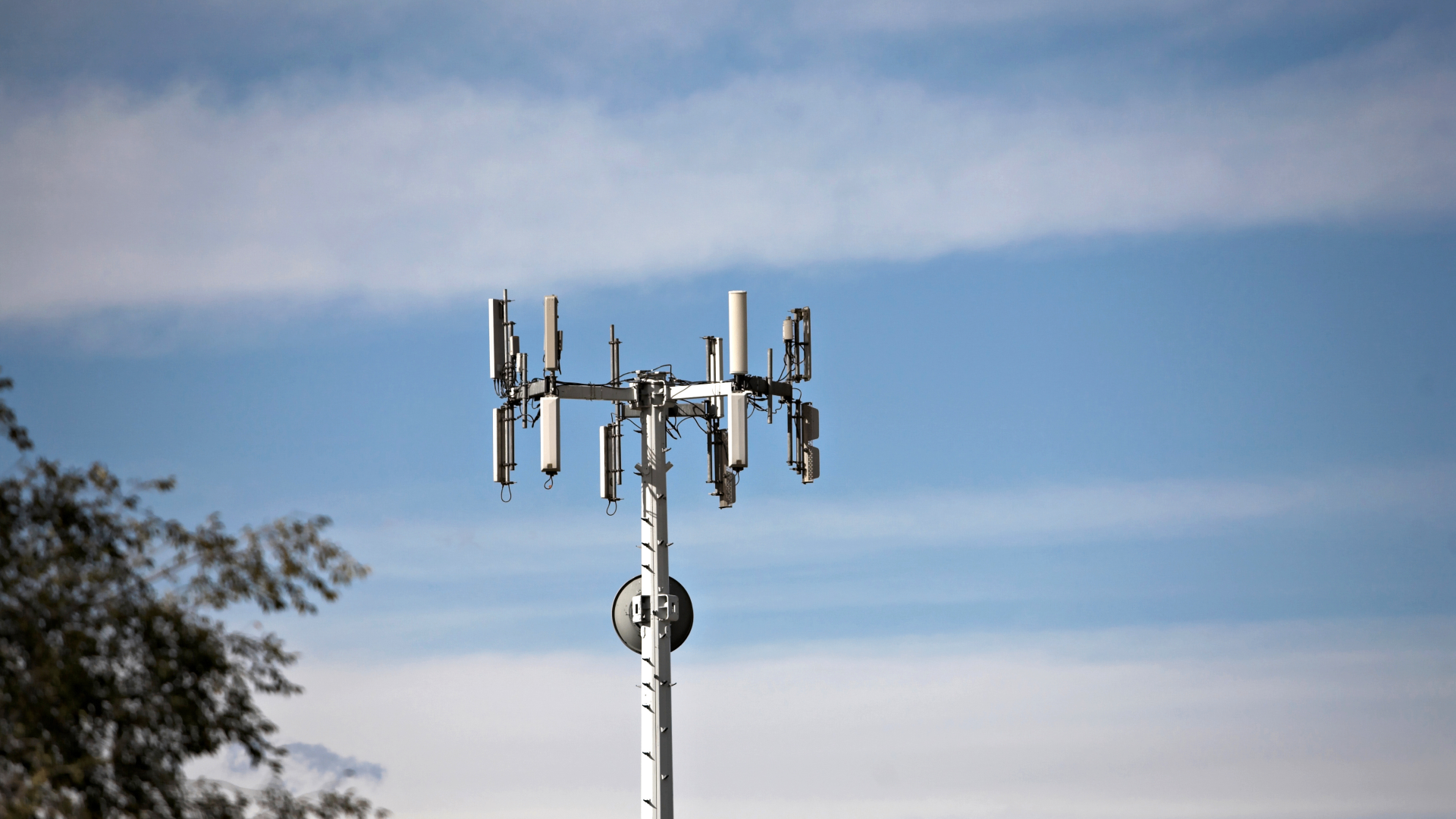Telecom tower top and antenna elements captured from the ground for inspection review.